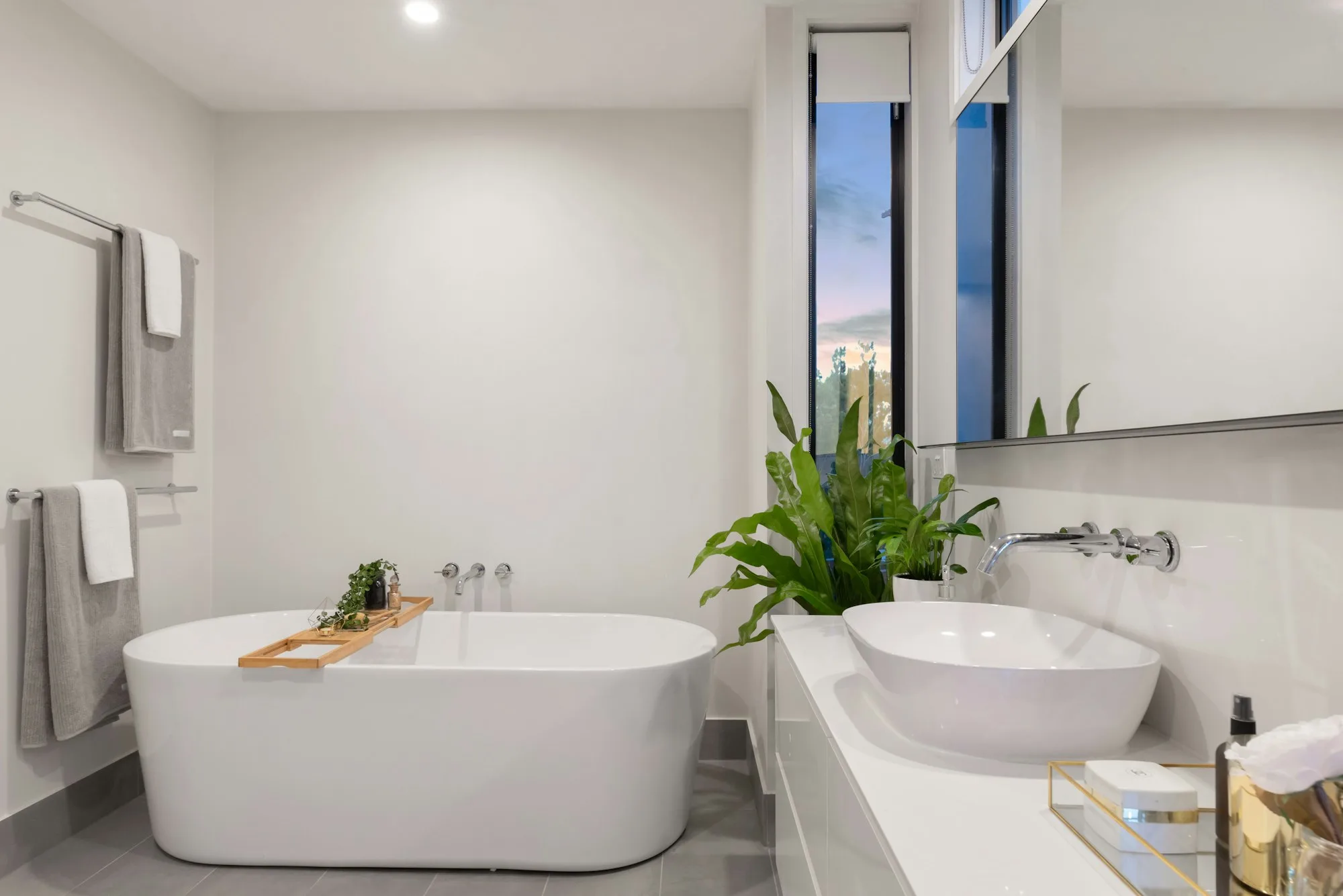Spa-style bathroom with freestanding tub and large windows