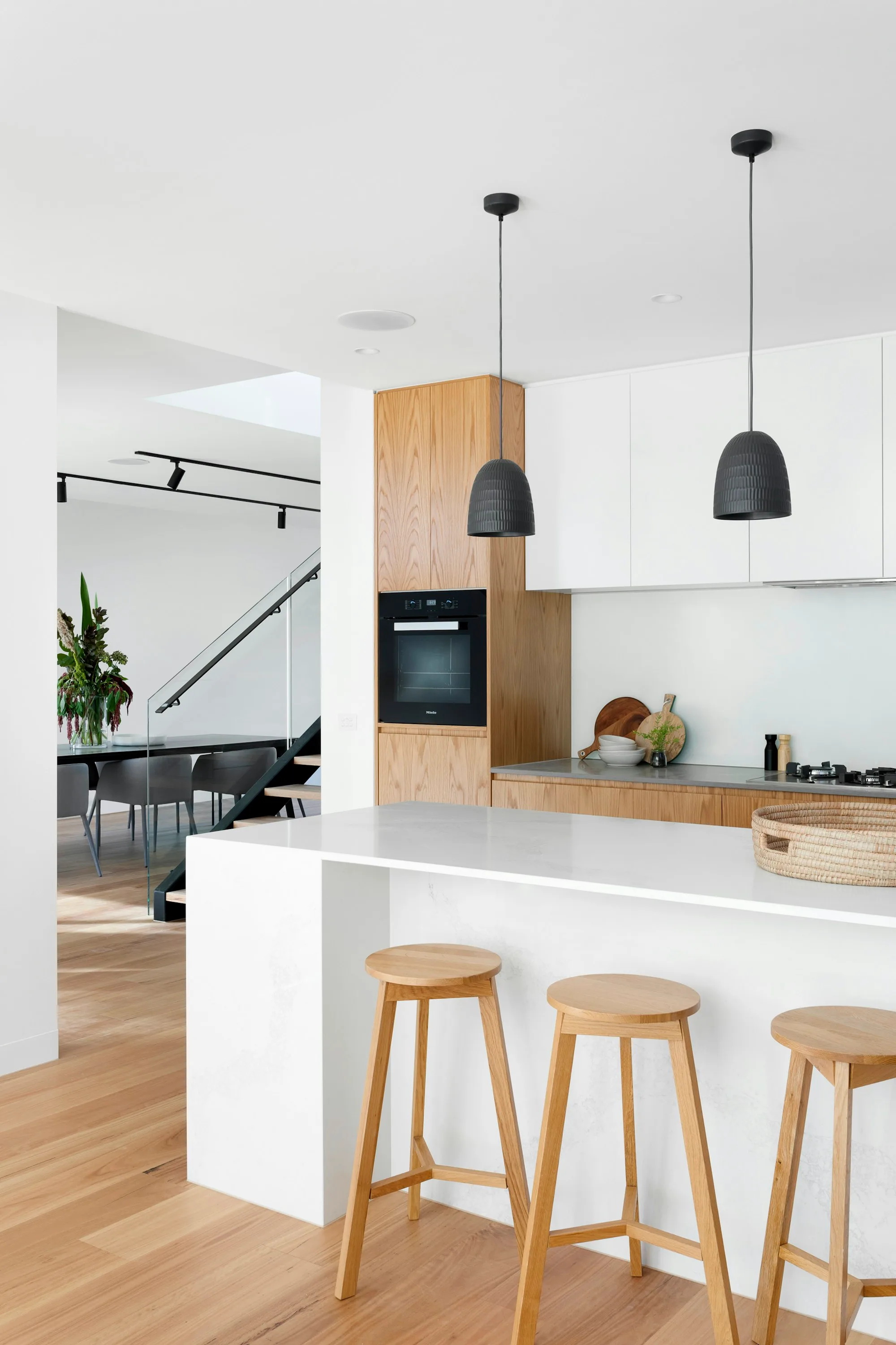 Remodeled kitchen with white oak cabinets and quartz counters