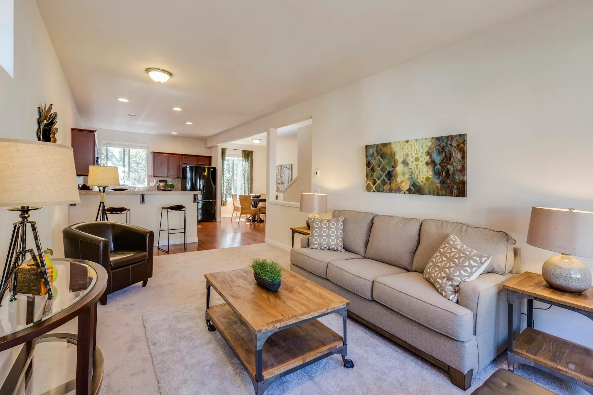 Beige living room with worn carpet before the remodel