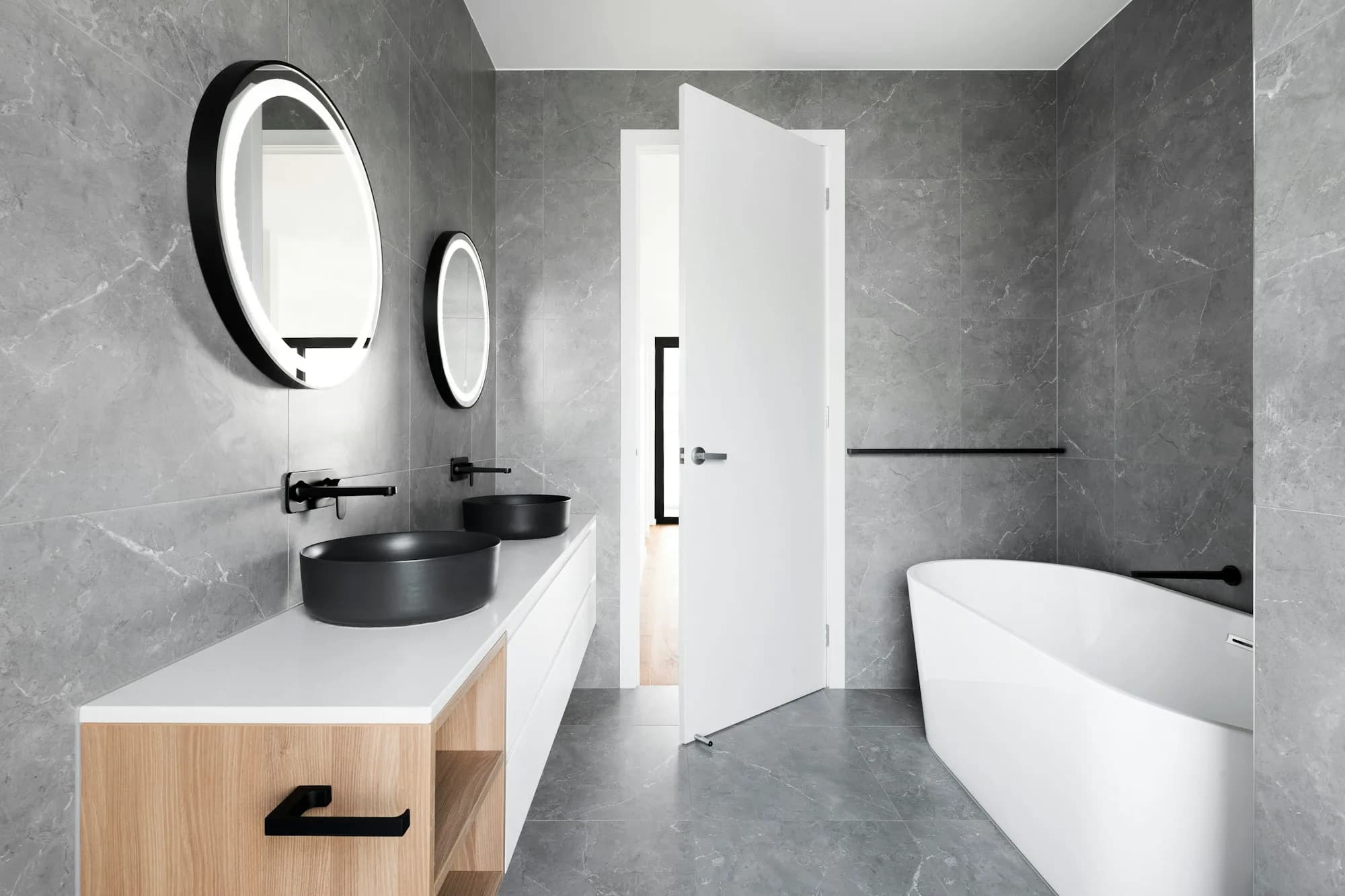 Marble bathroom with a freestanding tub and double vanity