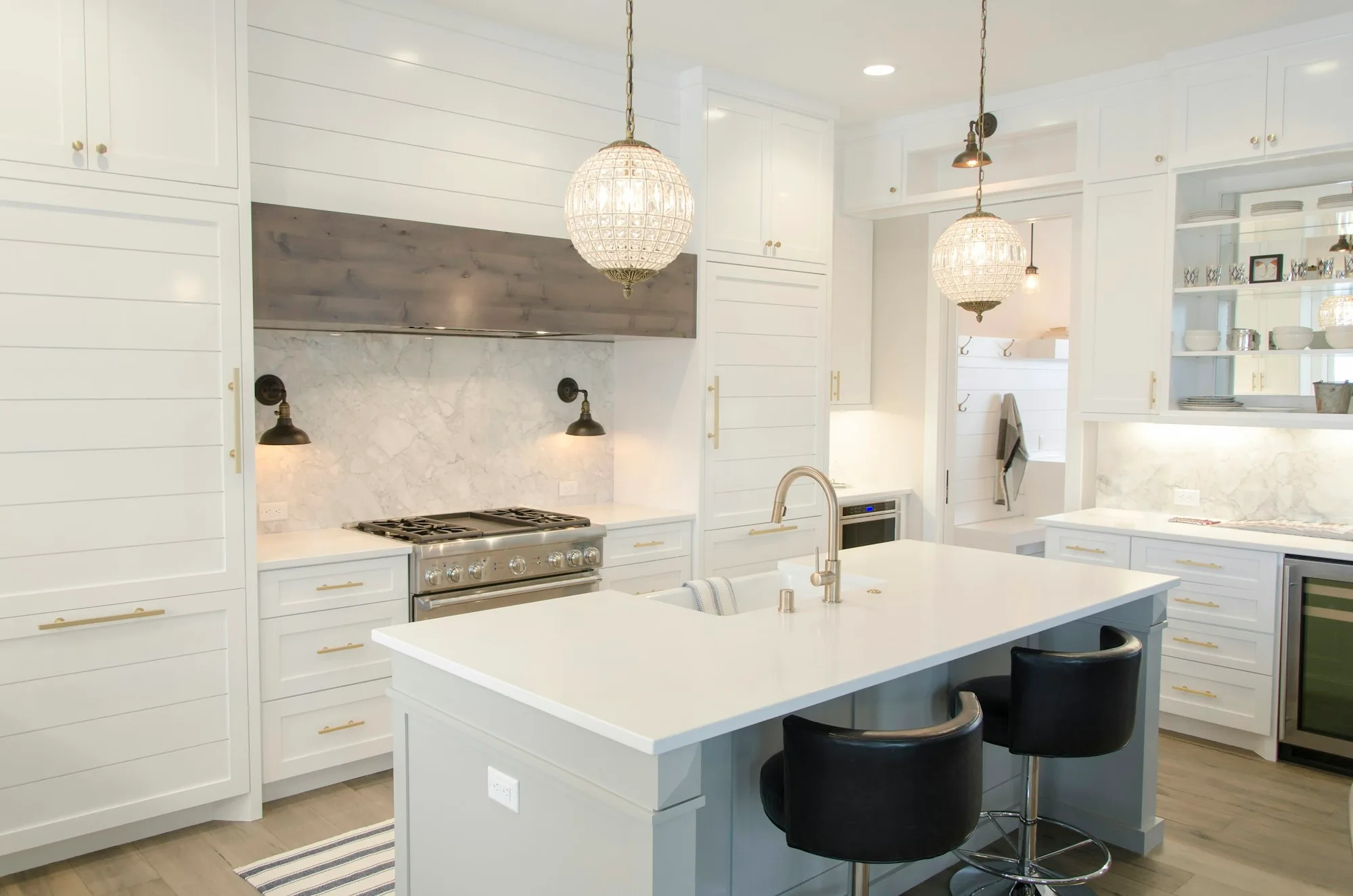 Bright white kitchen with a large island and pendant lights