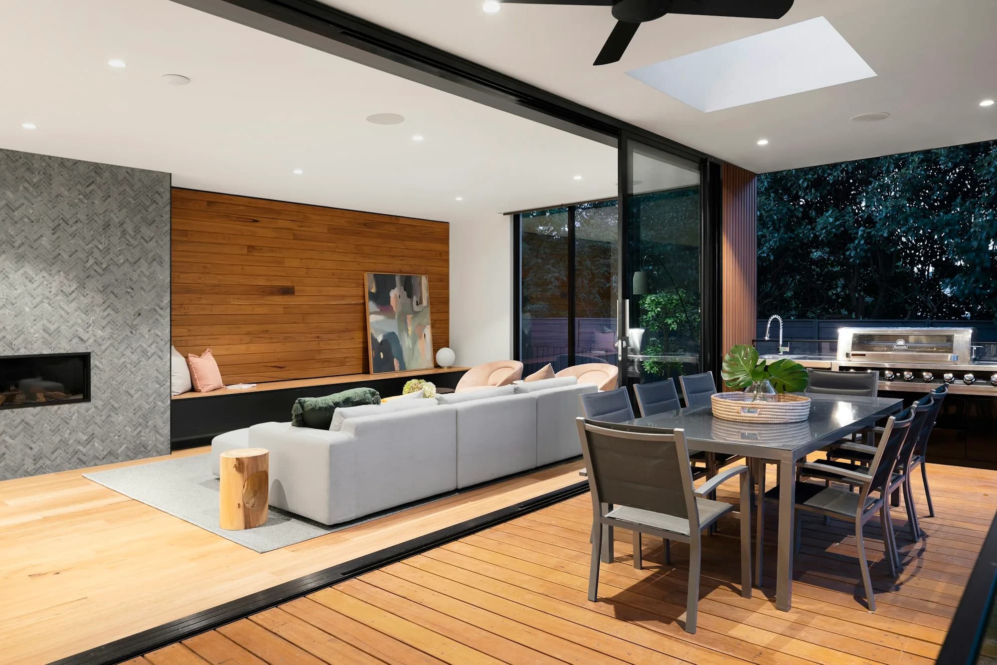 Covered patio with outdoor kitchen opening to a backyard